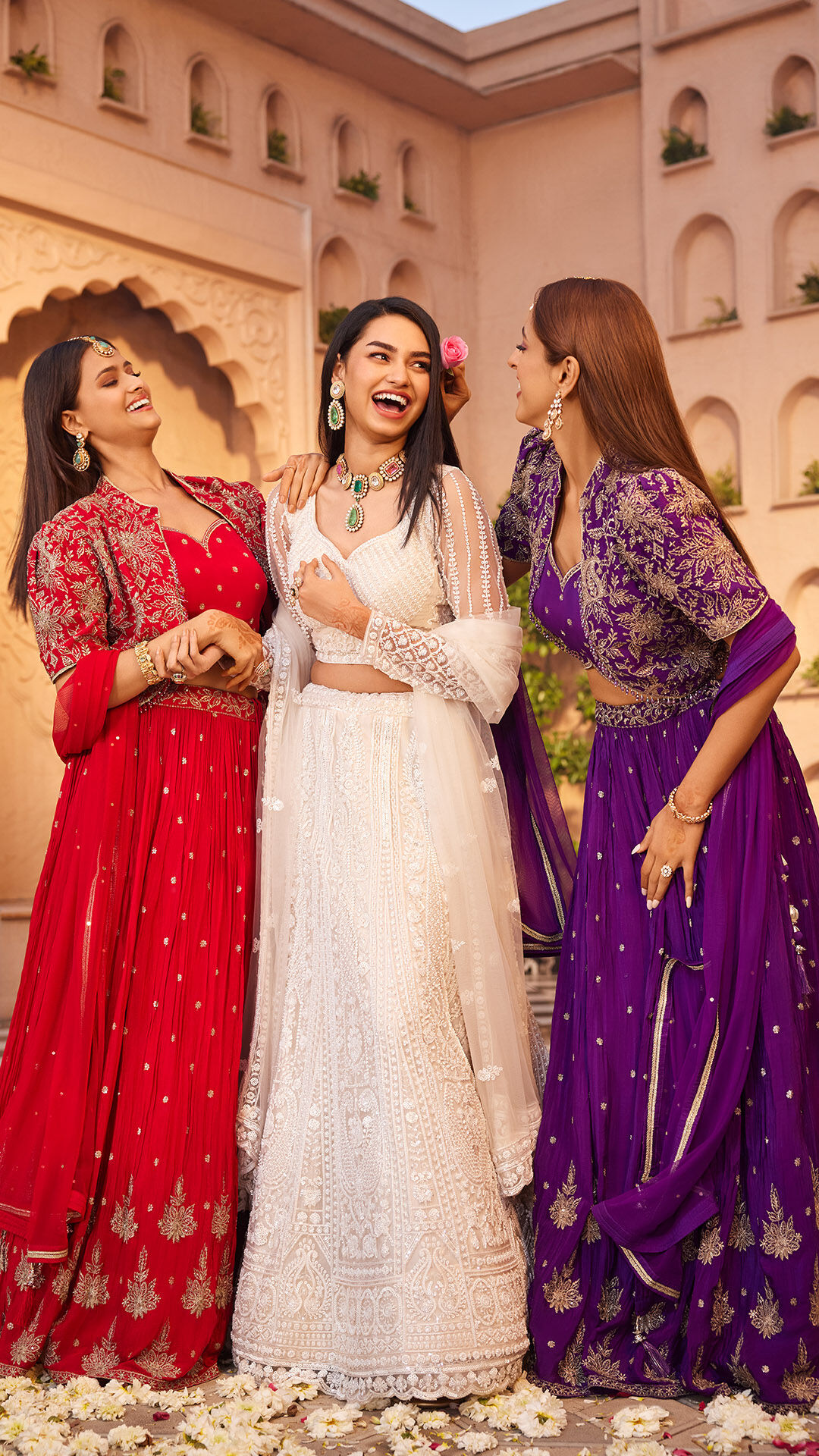Womens smiling and enjoying in wedding wearing colourfull lehengas